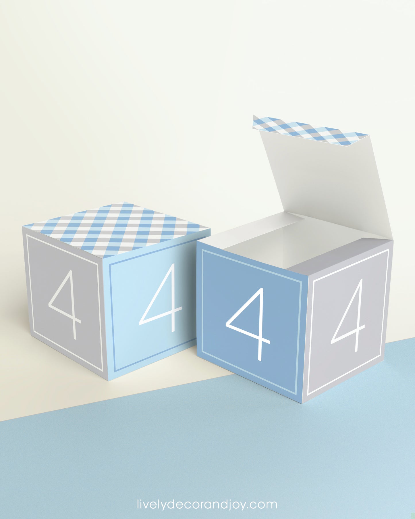 Two paper building blocks and the number 4 on the sides. One is a closed cube, the other an open box.