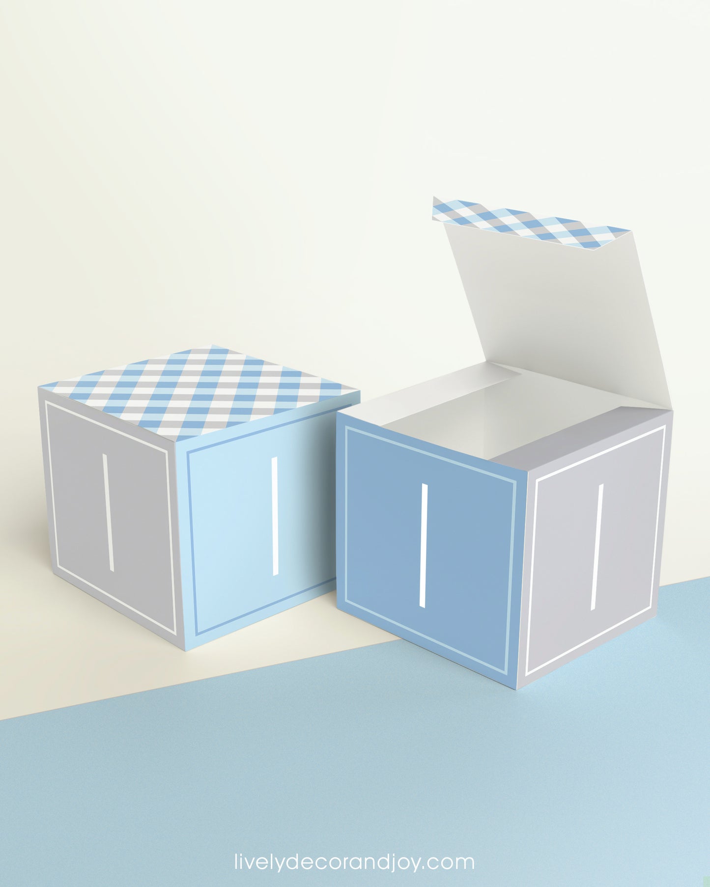 Two alphabet blocks with the capital I on the sides. One has the top open showing that it is also a paper box.