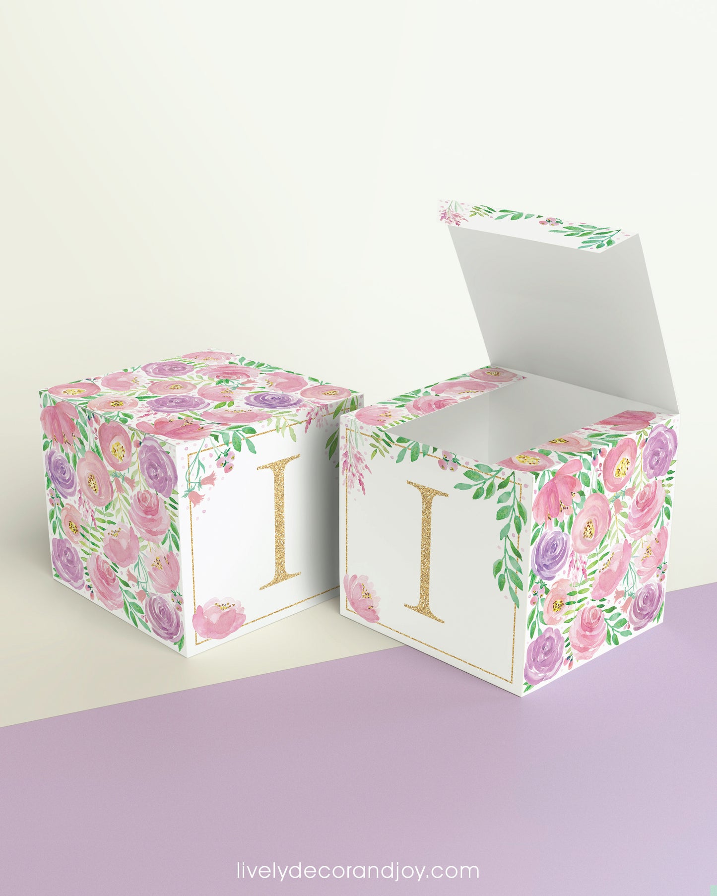 Two paper cubes with floral designs. They have a capital I on the front. One has the top open showing that it is a paper box.