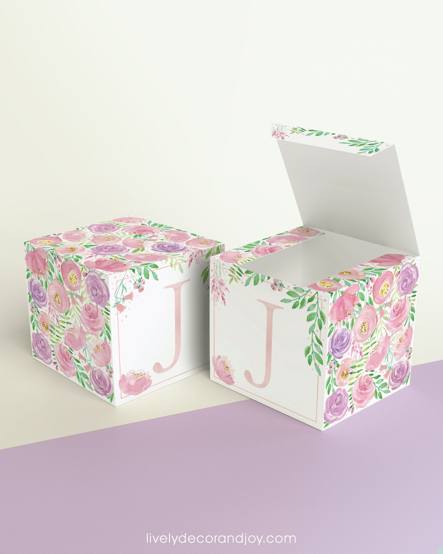 Two paper cubes with floral designs. One has the top open to show that the printable design can be used for blocks or boxes.