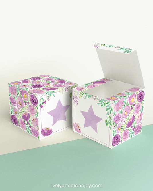 Paper building block with floral designs and a lavender star on the front presented twice: as a cube and also as an open box.