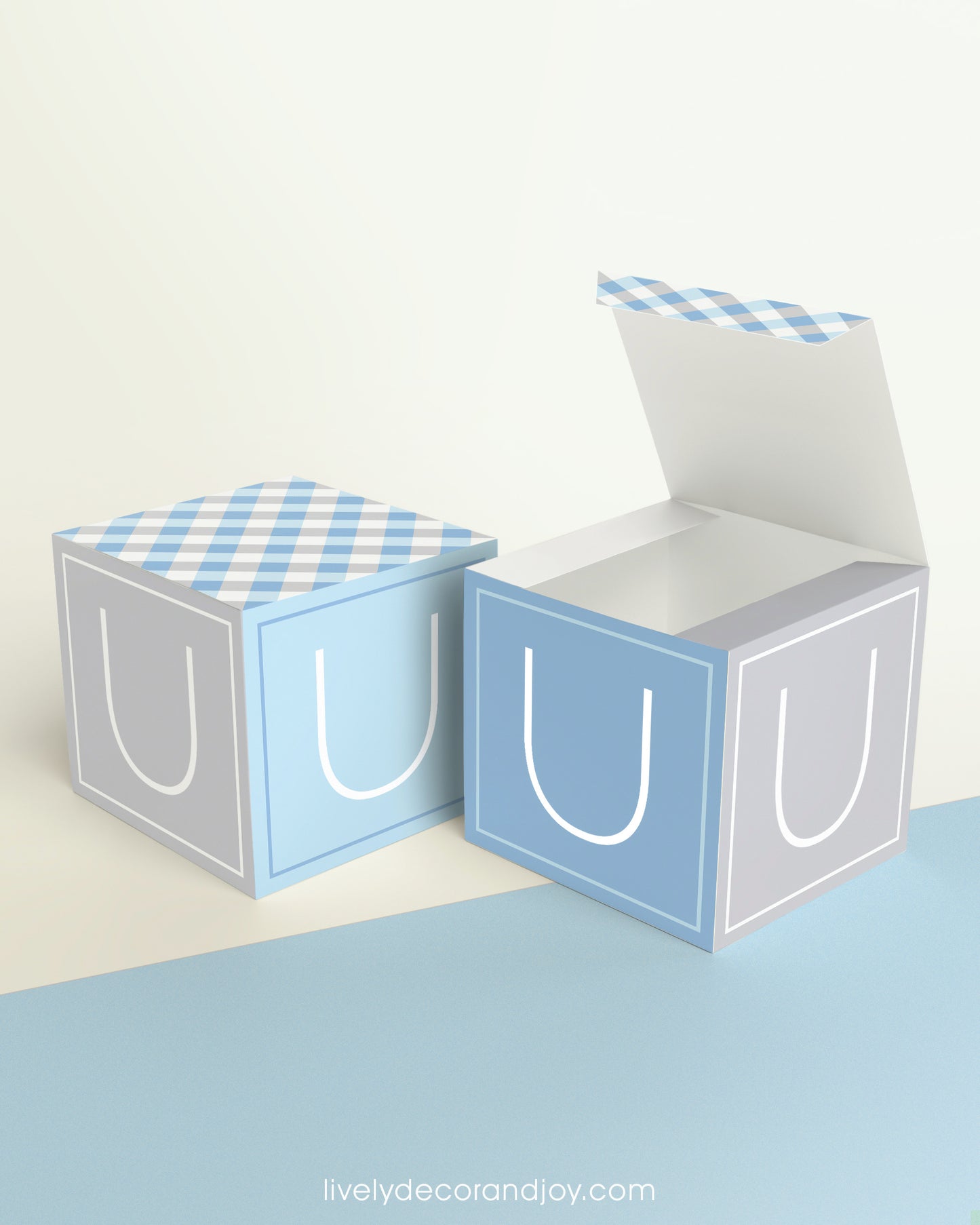 Two printed DIY paper cubes have the same design, one of which has an open lid, showing that it is a box.