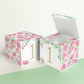 Paper cube shown as a closed block and also as an open box. It has pink floral designs and the number 1 in gold.