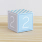 ABC block in blue and light grey with the number 2 on the sides. It is made of paper.