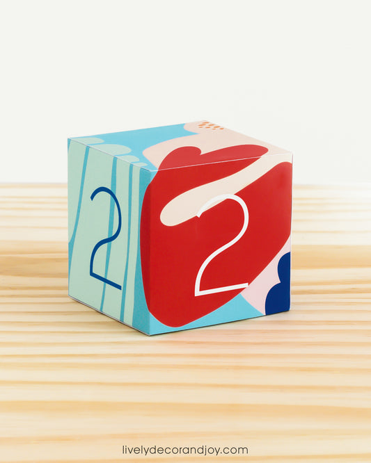 Ocean inspired paper ABC block in reef colors with the number 2 on the sides. Features modern abstract designs.