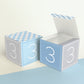 Two paper cubes with the number 3 on the sides. One has the lid open, showing it is a box. Both made with the same template.