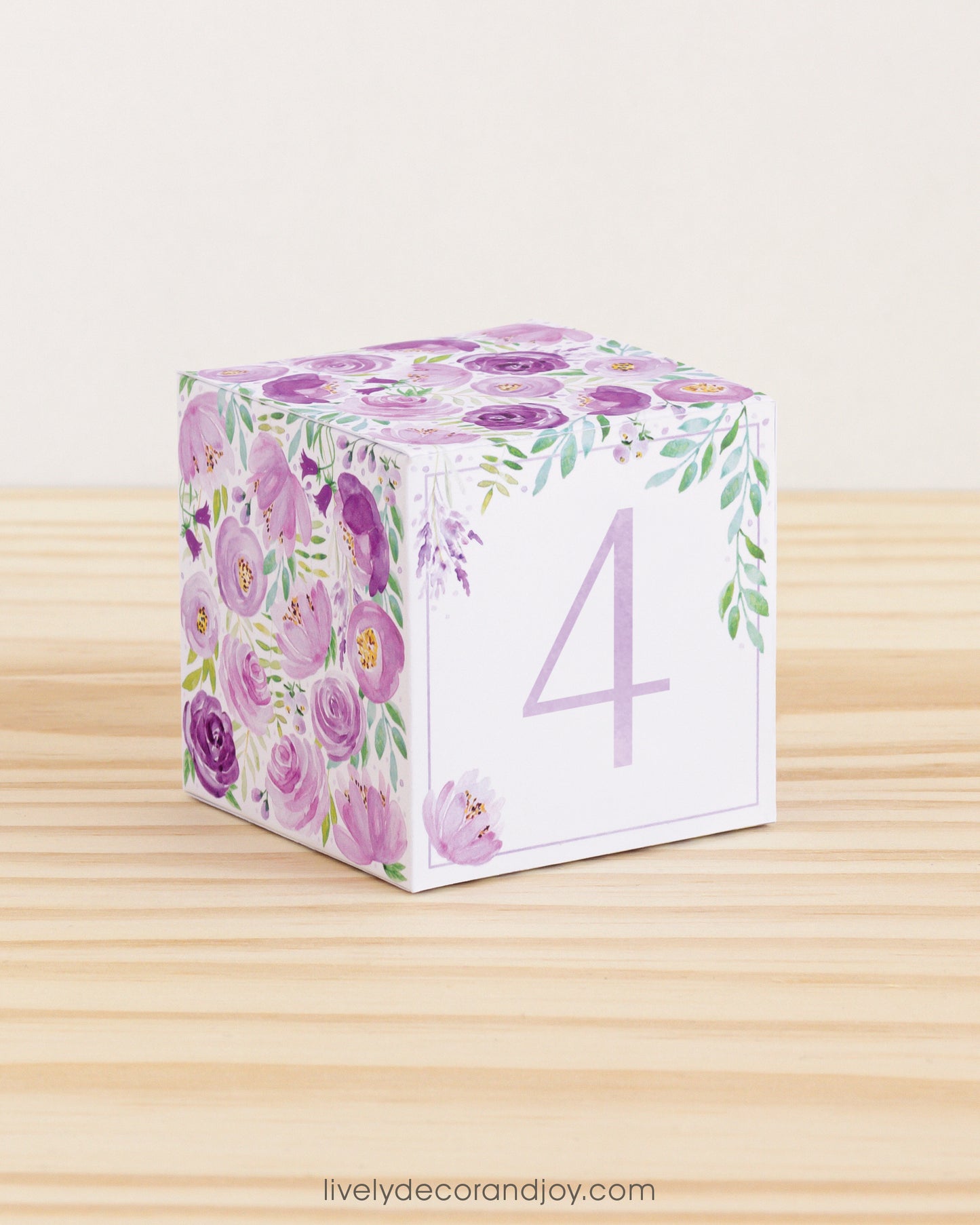 Building block with floral design and lavender number 4 on the front. Part of a collection of printable alphabet blocks.