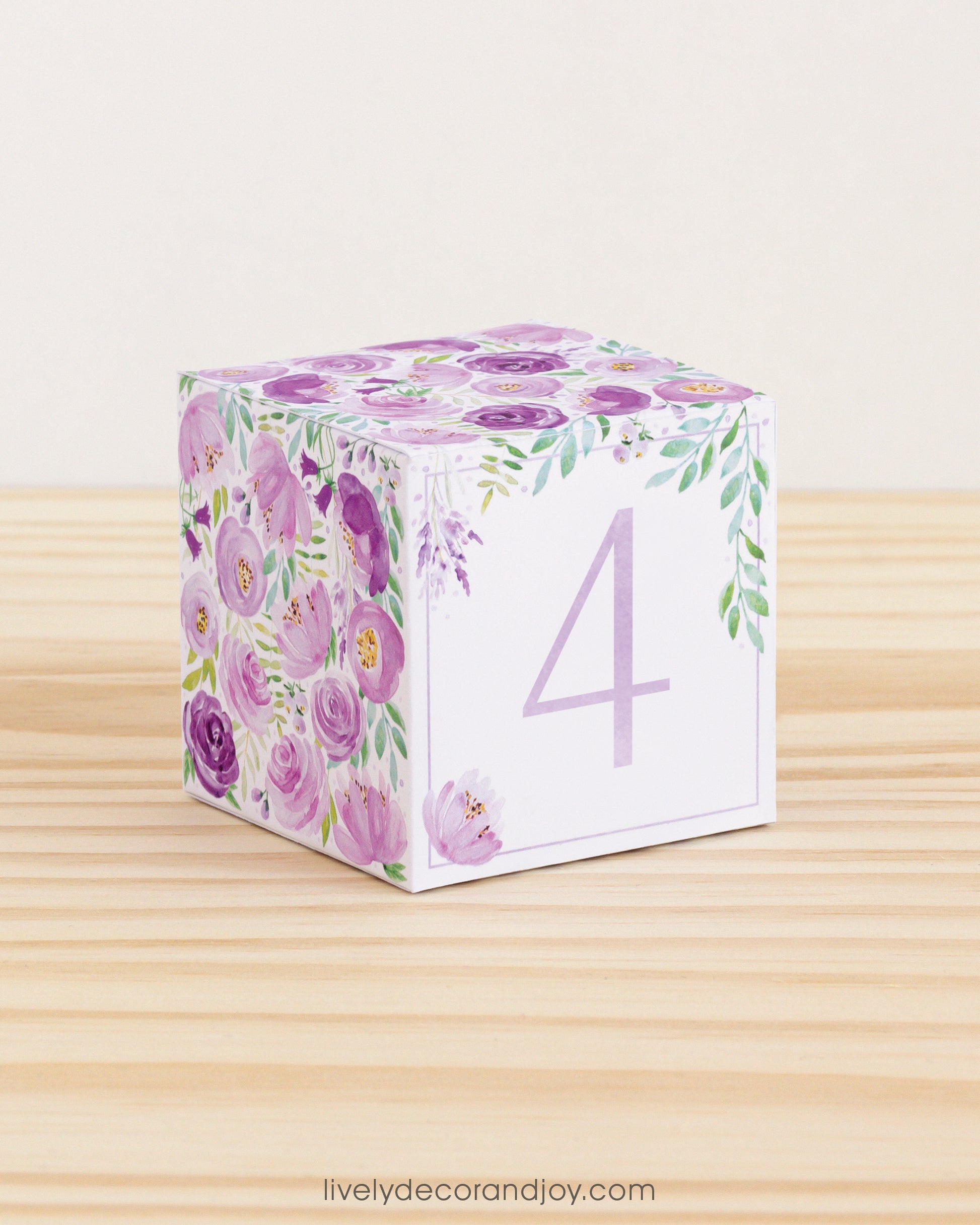 Building block with floral design and lavender number 4 on the front. Part of a collection of printable alphabet blocks.