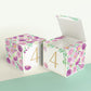 Two paper building blocks with floral designs and a gold number 4 on the front. One is a closed cube, the other an open box.
