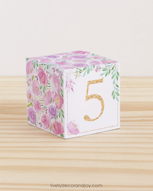 Paper building block with the number 5 in peach and floral designs in blush and lavender. Made from a printable template.