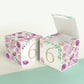 Two paper cubes with purple floral designs and the digit 6 in gold. One has the top open, showing it can be a block or a box.