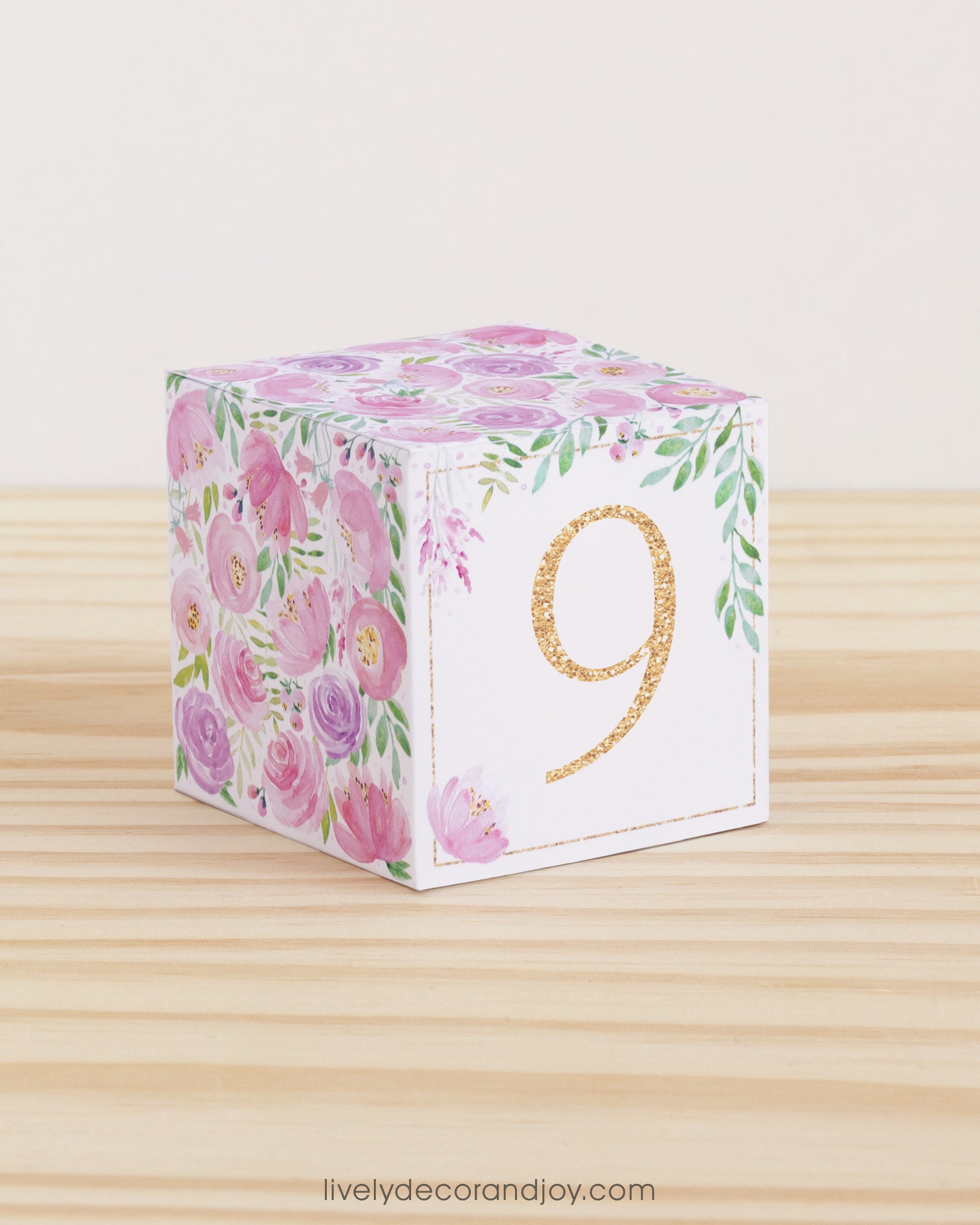 Paper building block with the number 9 in peach and floral designs in blush and lavender. Made from a printable template.
