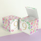 Two paper cubes with a number 9 on the front. One has the lid open, showing it is a box. Both made with the same template.
