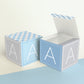 Two paper cubes with the same design and the capital A on the sides. One has the lid open showing it can also be a box.