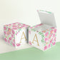 Two paper cubes with the same floral design and a capital A on the front. One has the lid open showing it can also be a box.