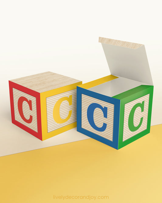 A paper cube in the classic wood block style with the letter C on the sides. The design is in primary colors and green.