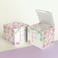 Two floral paper building blocks with the same feminine designs. One has an open top to show that it can also be a box.