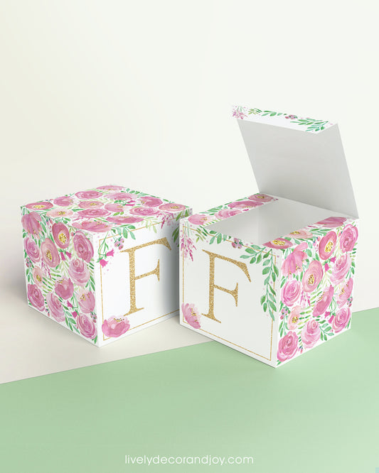 Two floral paper building blocks with the same feminine designs. One has an open top to show that it can also be a box.