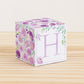 Paper cube with floral cottagecore motifs and a capital H on the front. It features purple and green flowers and leaves.