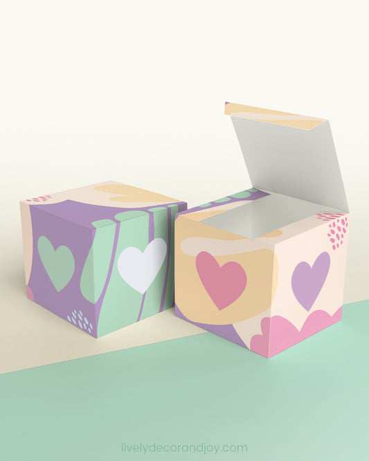 Two cubes with a heart on the sides. One has the lid open, showing it is a box. Both made with the same template.