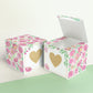 Two paper cubes with a gold heart on the front. One has the lid open, showing it is a box. Both made with the same template.