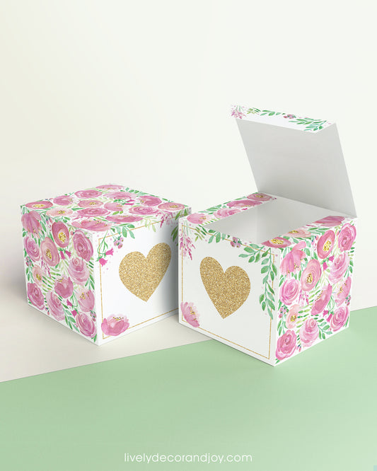 Two paper cubes with a gold heart on the front. One has the lid open, showing it is a box. Both made with the same template.