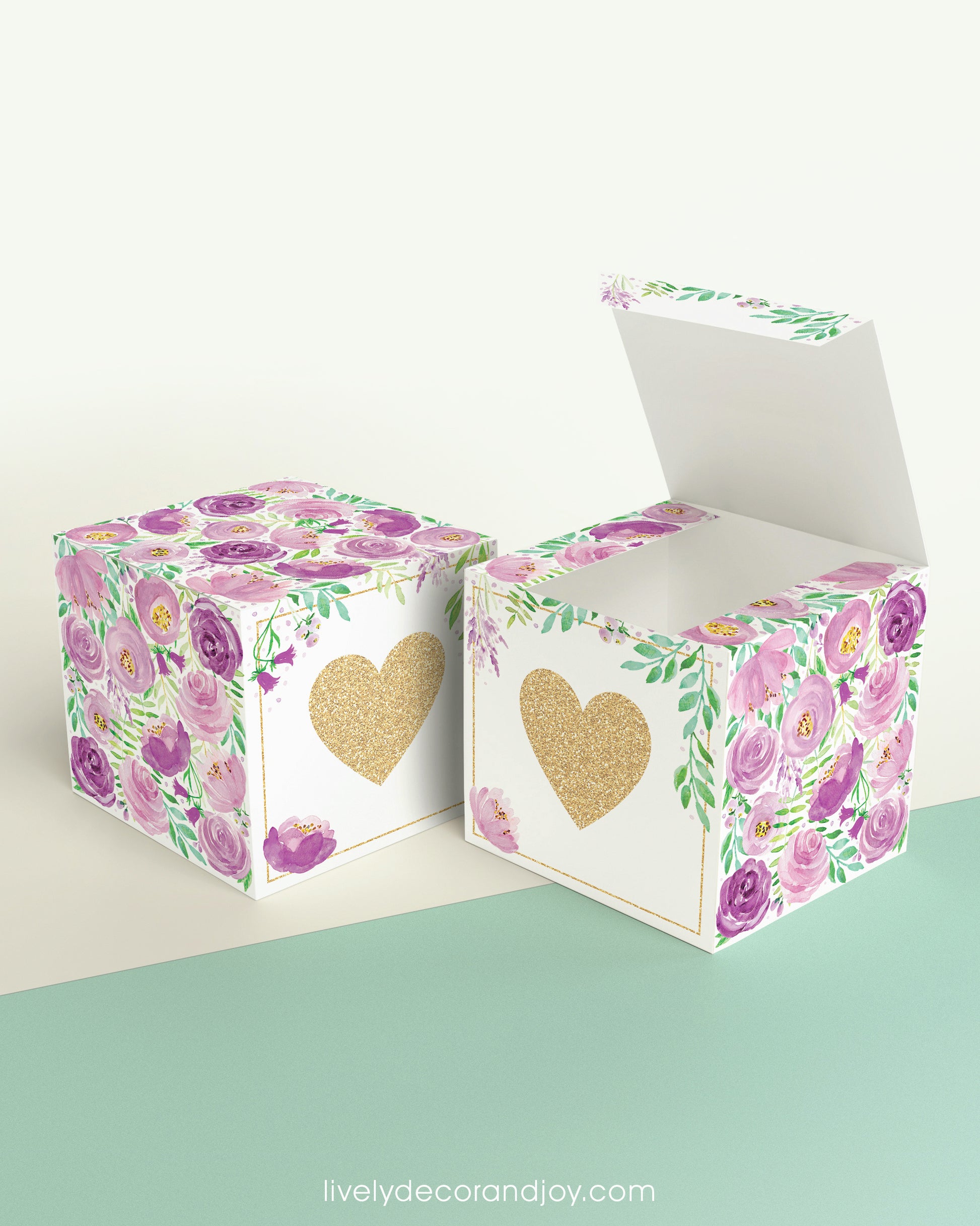Two paper cubes with a gold heart on the front. One has the lid open, showing it is a box. Both made with the same template.