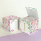 Two paper cubes with floral designs. They have a capital I on the front. One has the top open showing that it is a paper box.