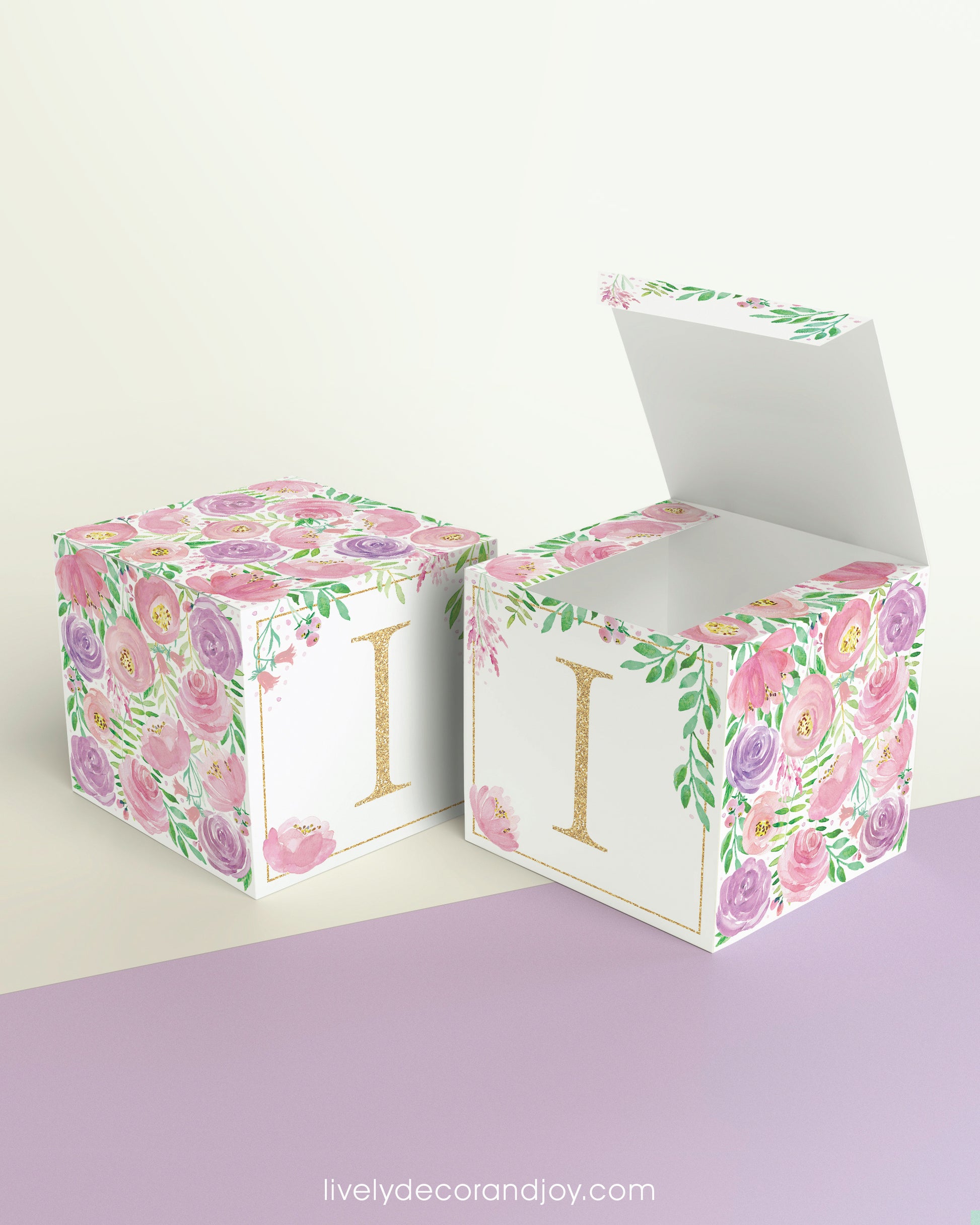 Two paper cubes with floral designs. They have a capital I on the front. One has the top open showing that it is a paper box.