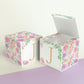 Two paper cubes with floral designs. One has the top open to show that the printable design can be used for blocks or boxes.