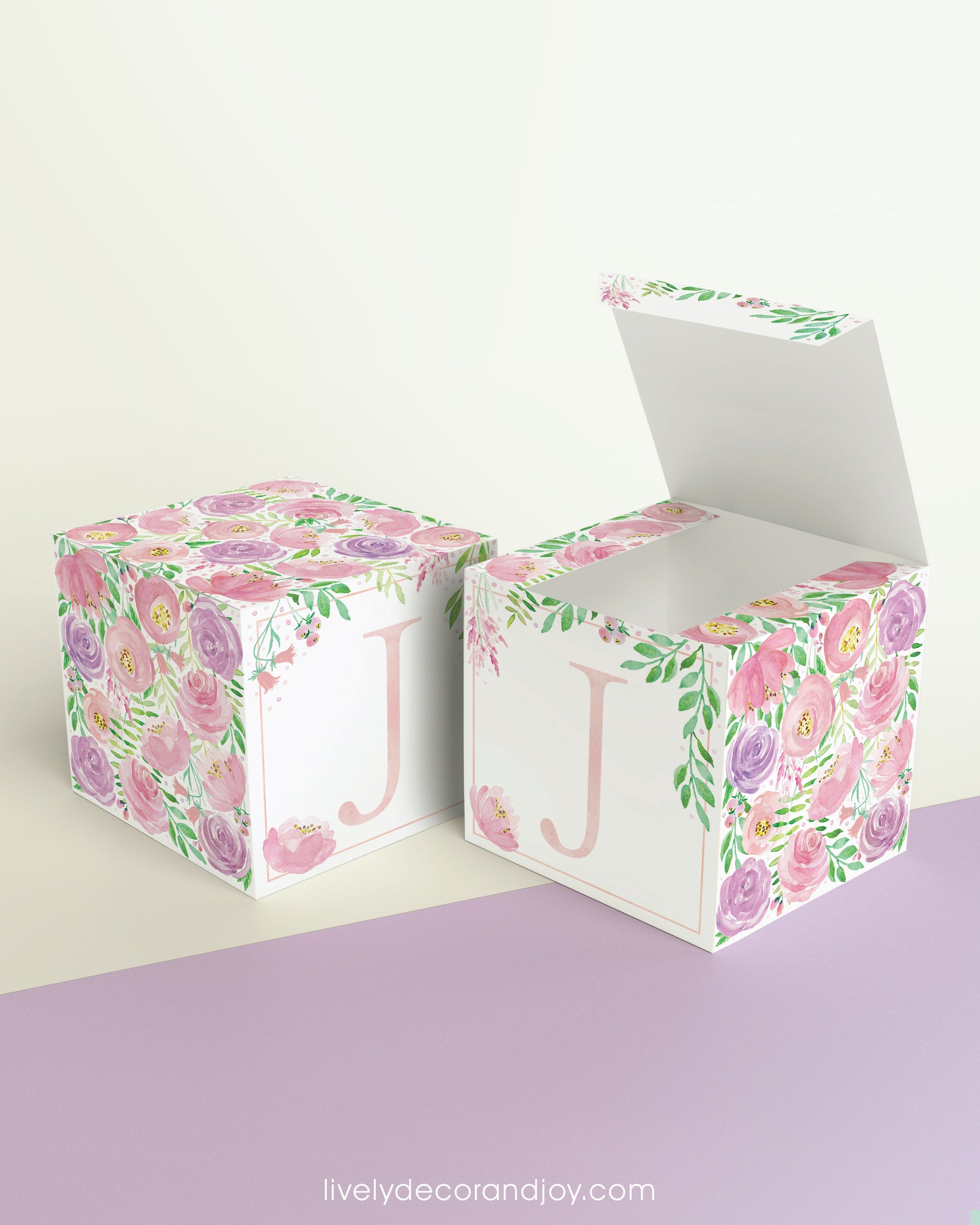 Two paper cubes with floral designs. One has the top open to show that the printable design can be used for blocks or boxes.