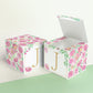 Two paper cubes with floral designs. One has the top open to show that the printable design can be used for blocks or boxes.