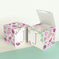 Two paper cubes with floral designs. One has the top open to show that the printable design can be used for blocks or boxes.