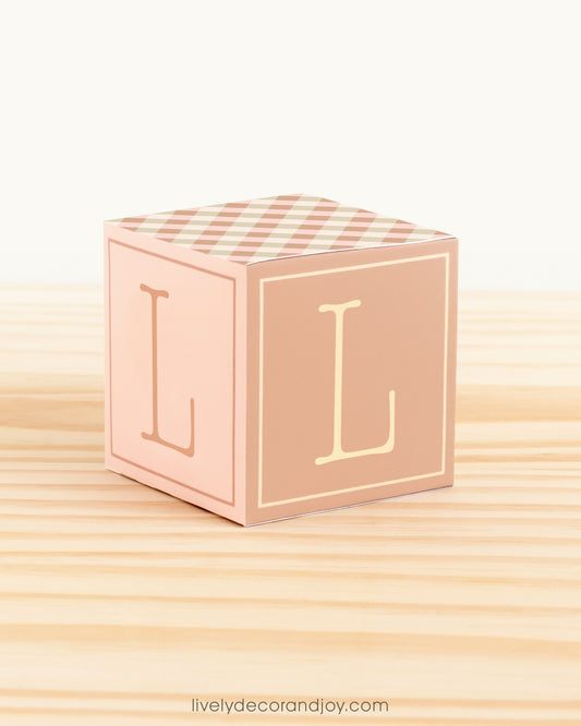 ABC block made of printed paper in farmhouse colors. Has the letter L on the sides.
