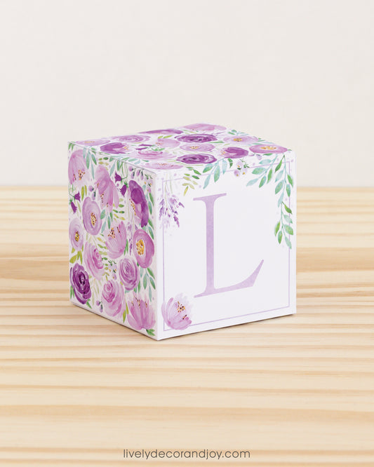 Cube with purple watercolor flowers and green leaves all around and the letter L in lavender.