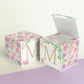 A completely closed block in the form of a cube and a box with an open lid. Both feature the same printable design.