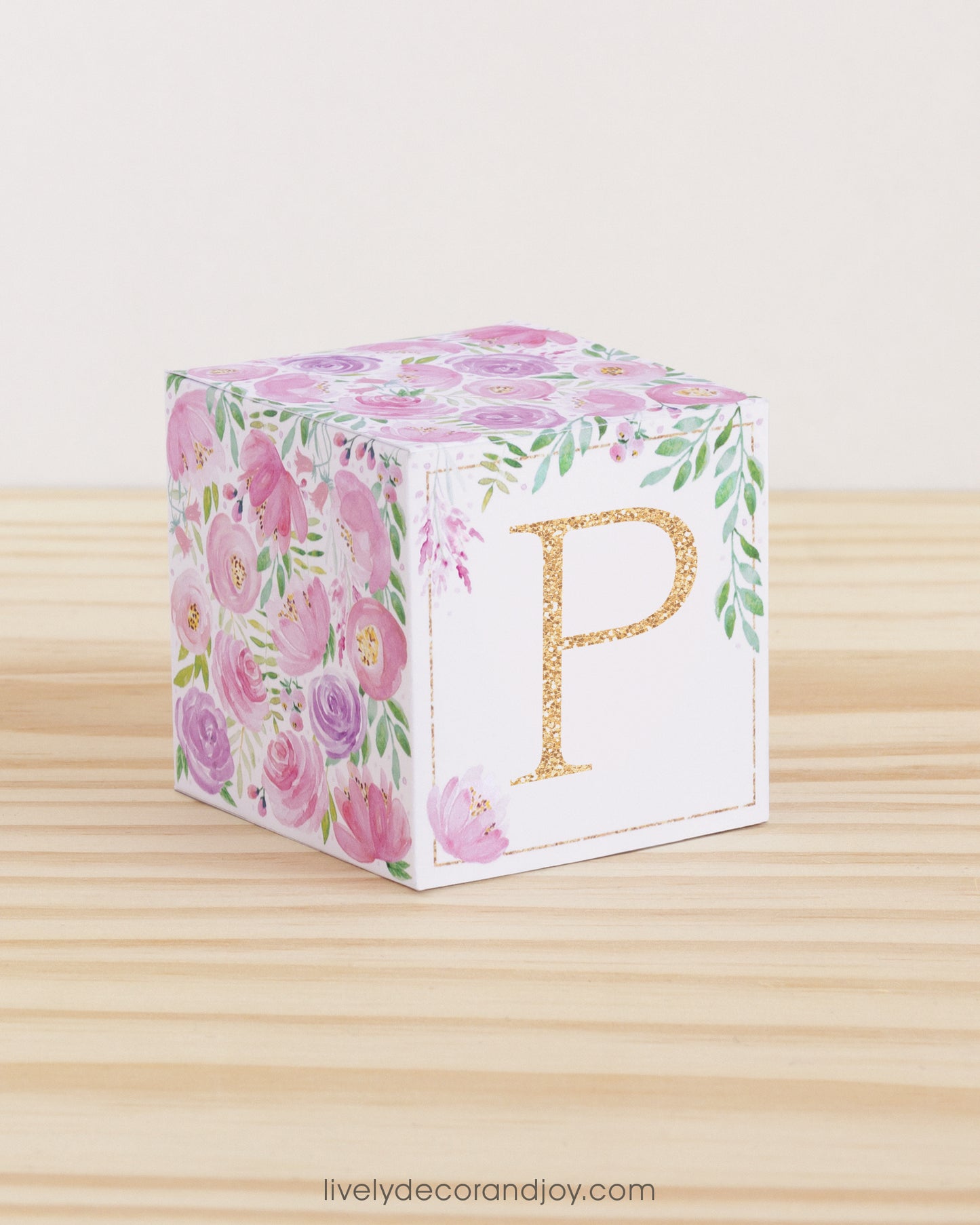 Paper building block features watercolor flowers in blush and lavender. A peach letter P is on the front.