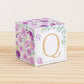 Letter block with printed boho floral designs and a gold letter Q on the front. It is made of paper.