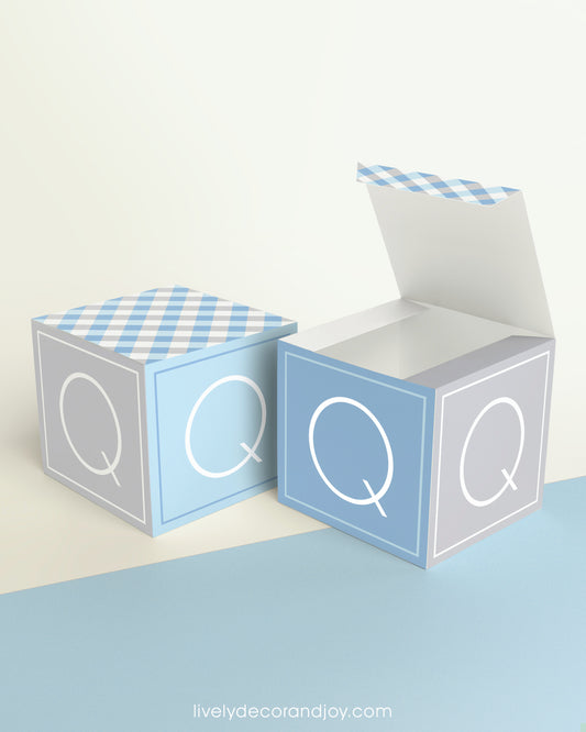 Two cubes, one has the top lid open. They look like modern alphabet wooden blocks but are made of printed paper.