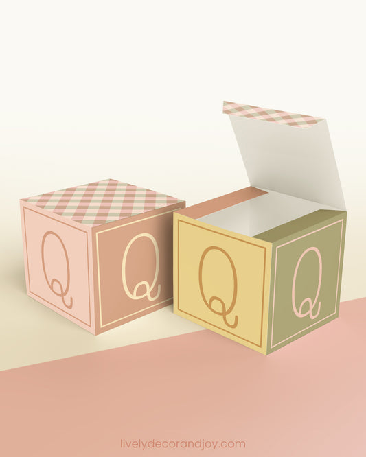 Two cubes, one has the top lid open. They look like vintage alphabet wooden blocks but are made of printed paper.