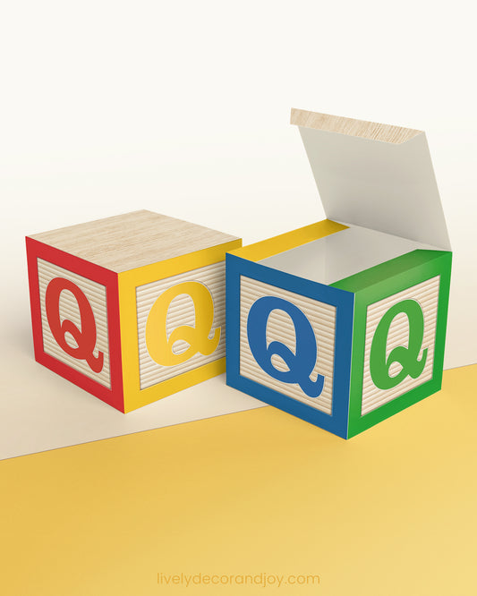 Letter block in primary colors with the letter Q on the sides. It is made of paper.