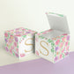 Two paper cubes with floral designs. They have a capital S on the front. One has the top open showing that it is a paper box.