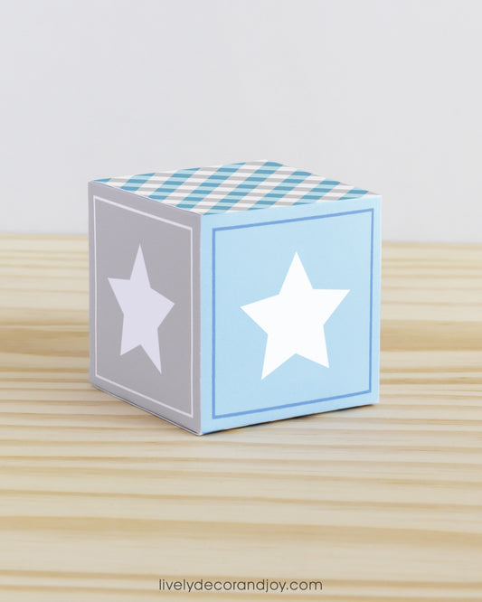 Building block with a star on the sides. Part of a collection of printable alphabet blocks in blue and light grey.