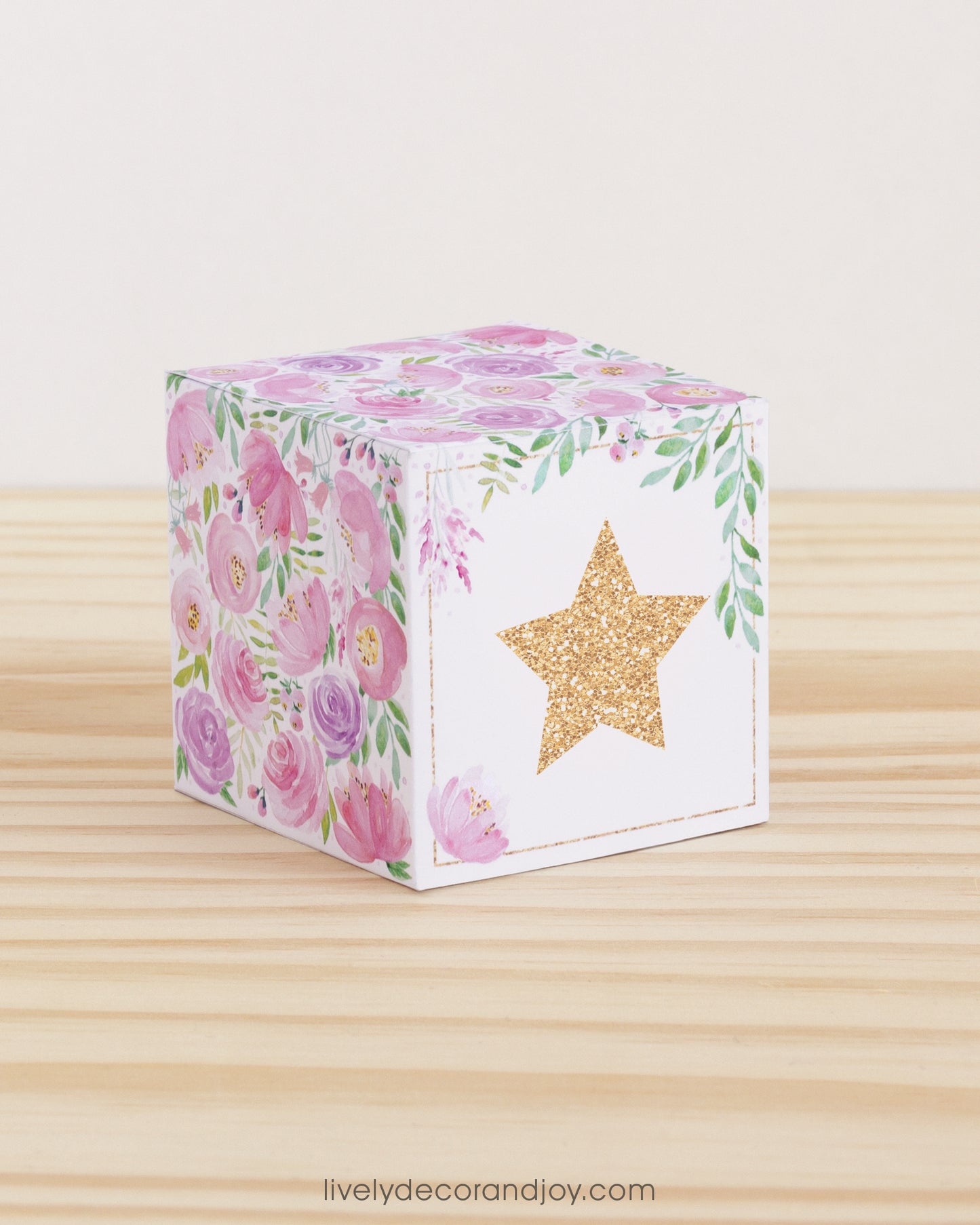 Building block with floral designs and a large star on the front. Part of a collection of printable building blocks.