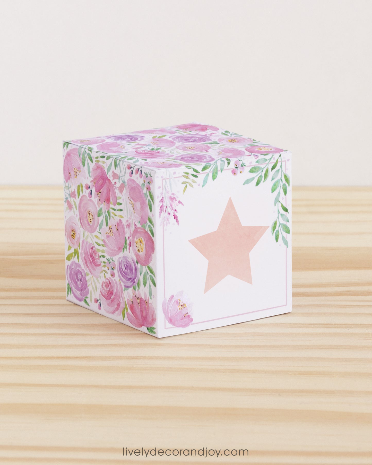 Building block with floral designs and a large star on the front. Part of a collection of printable building blocks.