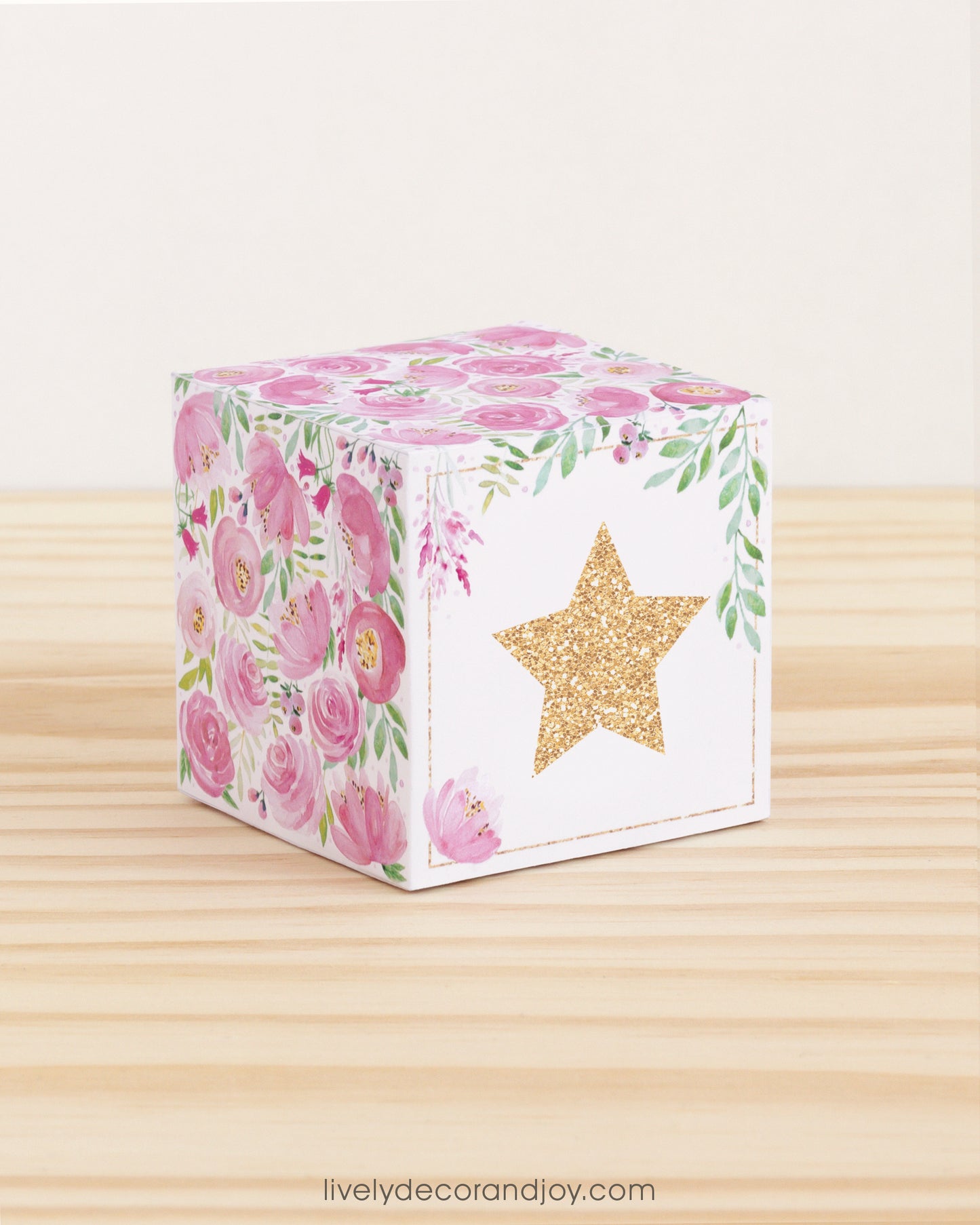 Building block with floral designs and gold star on the front. Part of a collection of printable alphabet building blocks.