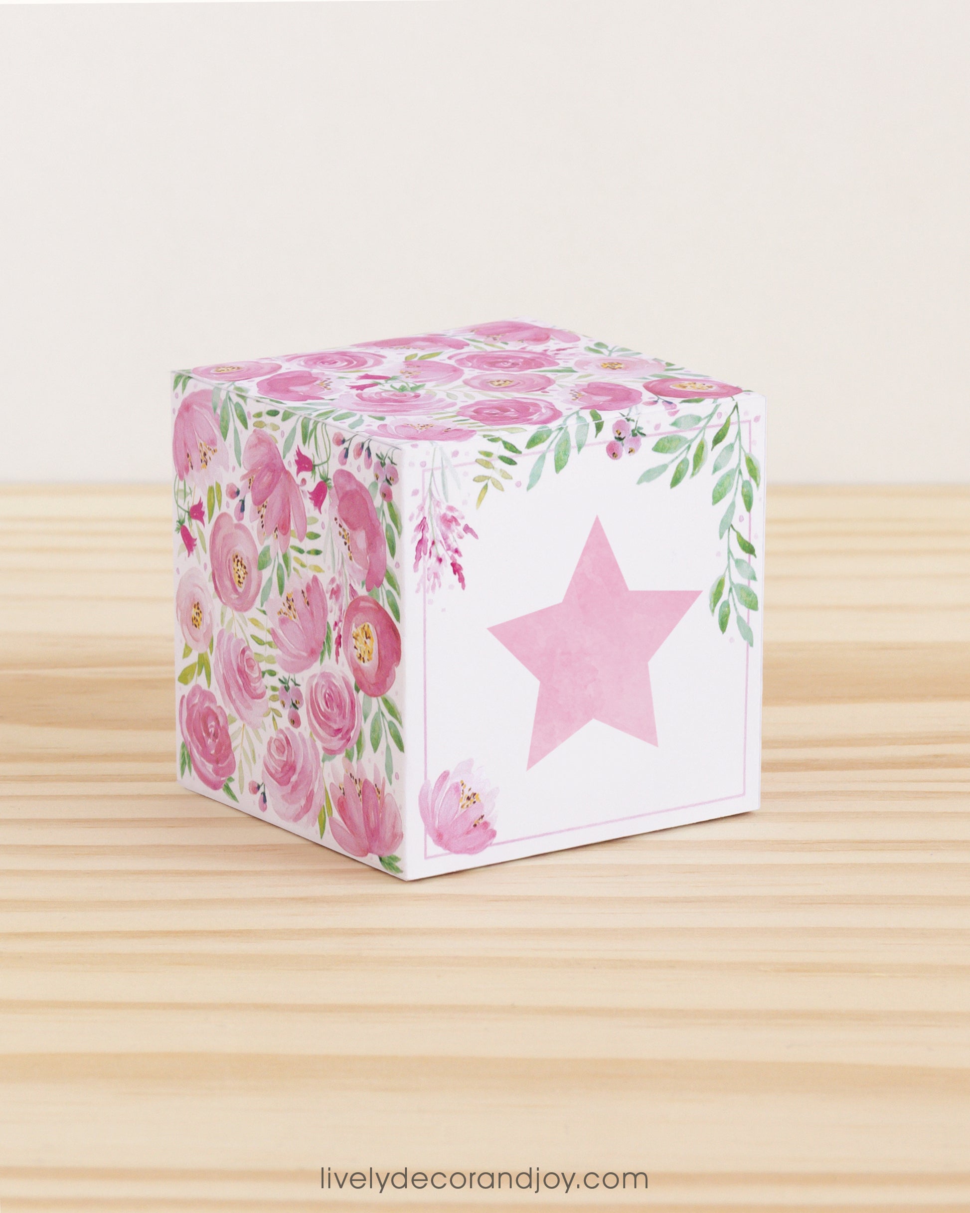 Building block with floral designs and pink star on the front. Part of a collection of printable building blocks.