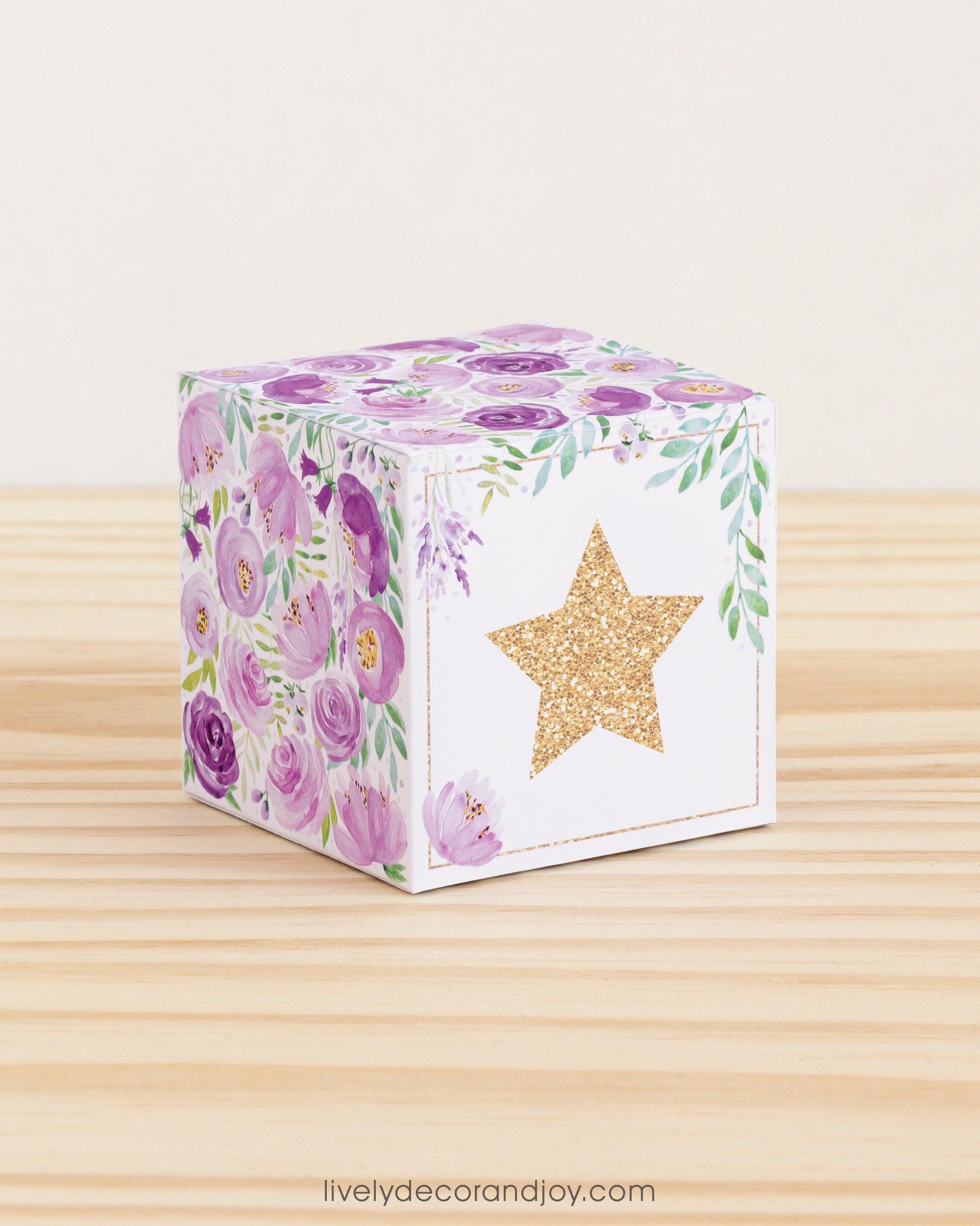 Building block with floral designs and gold star on the front. Part of a collection of printable alphabet building blocks.