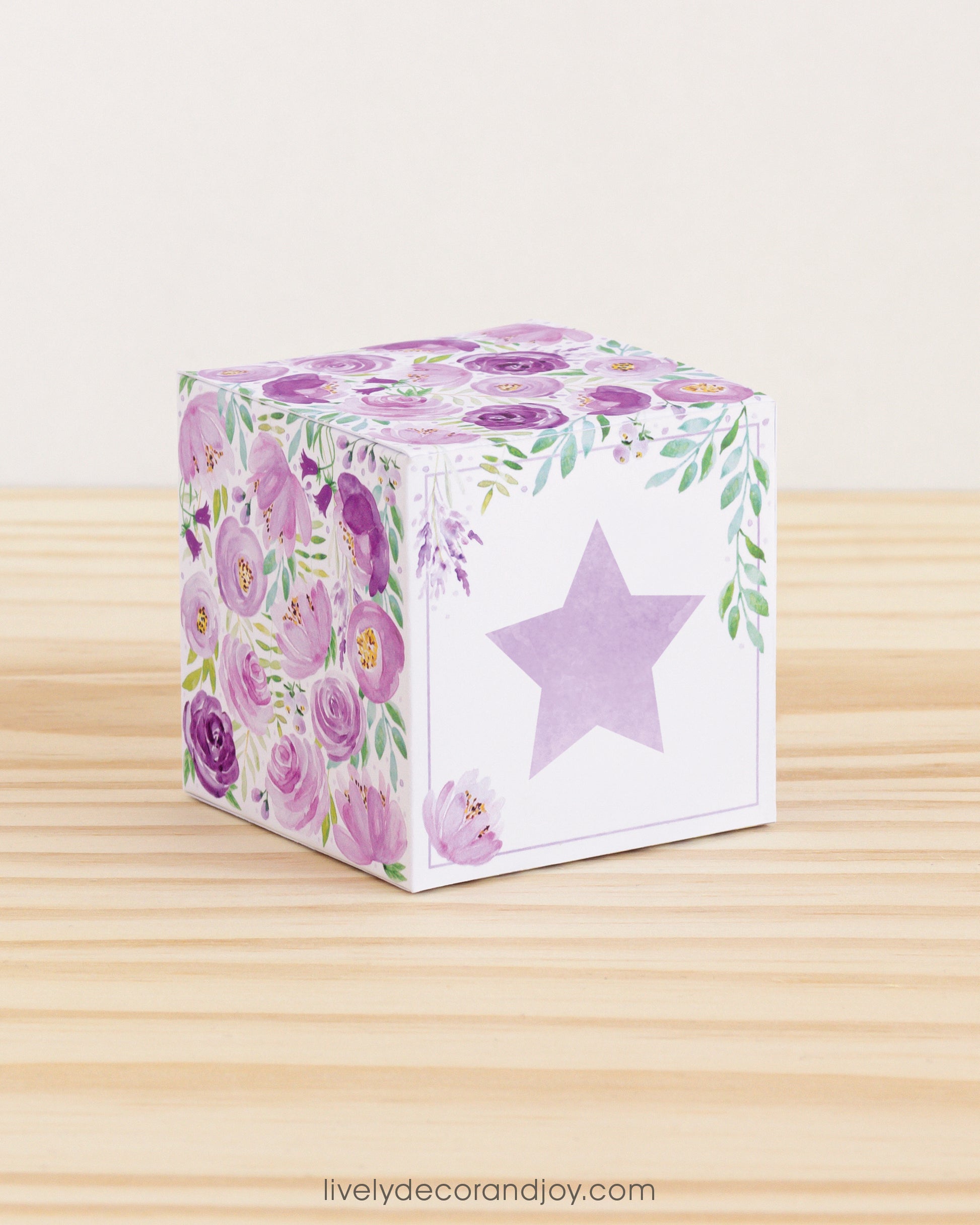 Building block with floral designs and lavender star on the front. Part of a collection of printable building blocks.