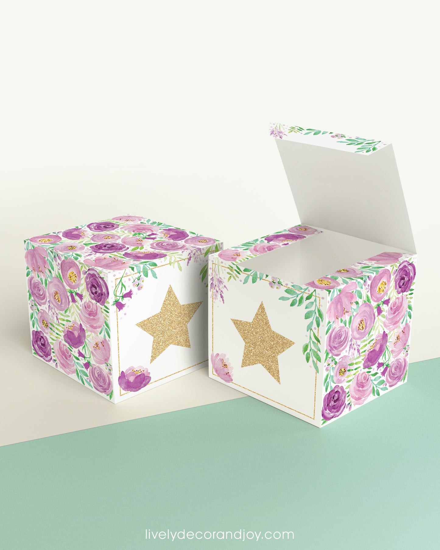 Paper building block with floral designs and a gold star on the front presented twice: as a cube and also as an open box.